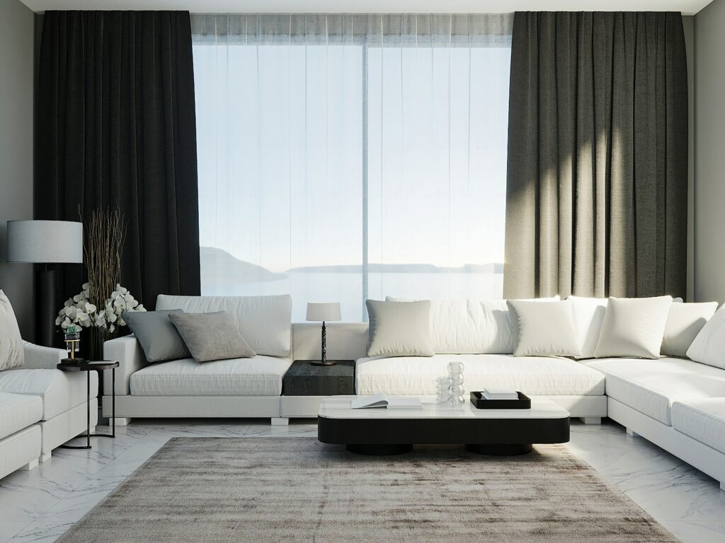 White corner sofa in luxury living guest room with black curtains and window on background